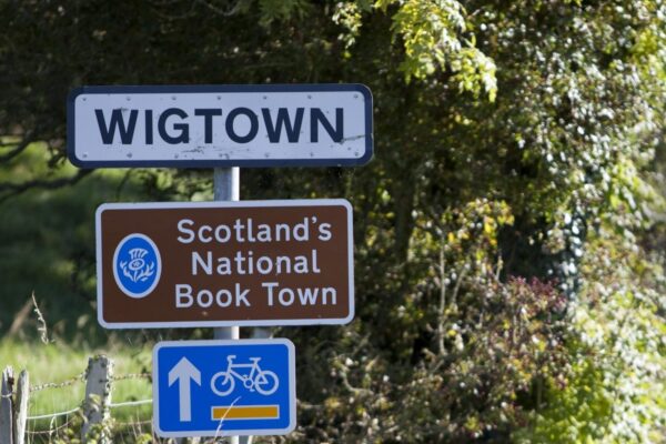 Arriving in Wigtown, Scotland's National Book Town. Road signage on a grassy verge