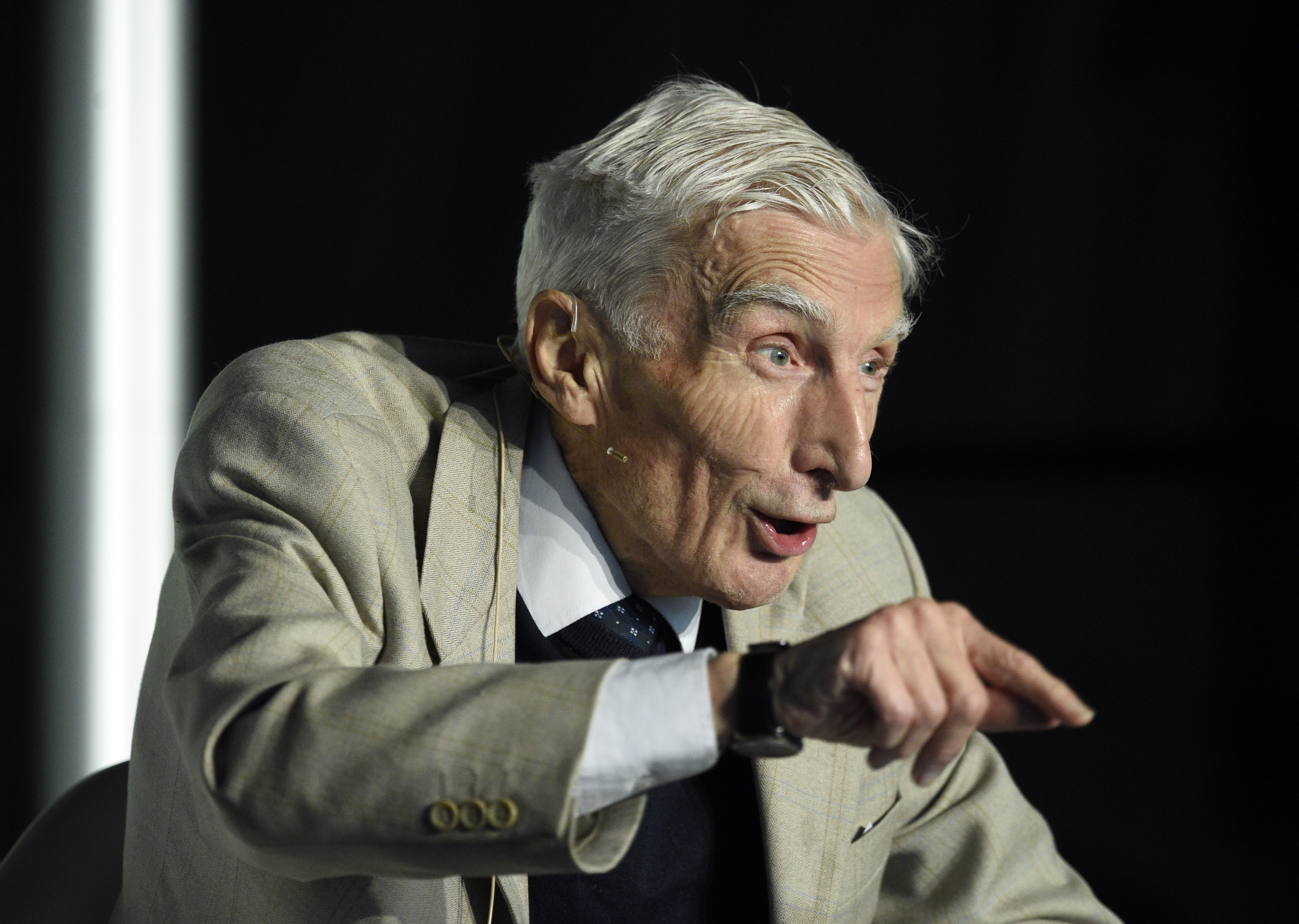 Astronomer Royal, Professor Lord Martin Rees is talking at his event at Wigtown Book Festival. He is pointing his finger towards the audience.