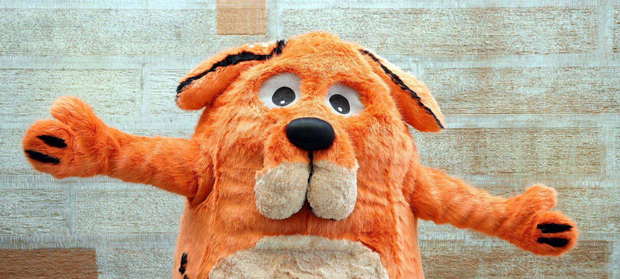 The Big Dog mascot, a large and fluffy orange dog, from the children's book festival taking place in Dumfries.