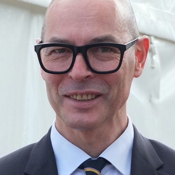 Nicholas Walker, Trustee at Wigtown Festival Company standing in front of a marquee at Wigtown Book Festival.