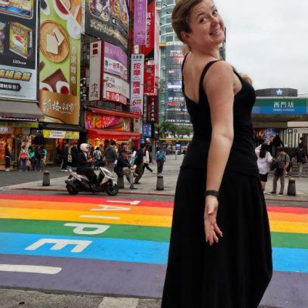 Aly Ford walking through a colourful street in Taipai.