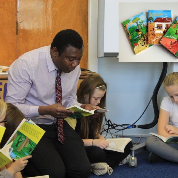 Bapula Chebe sitting reading to children.
