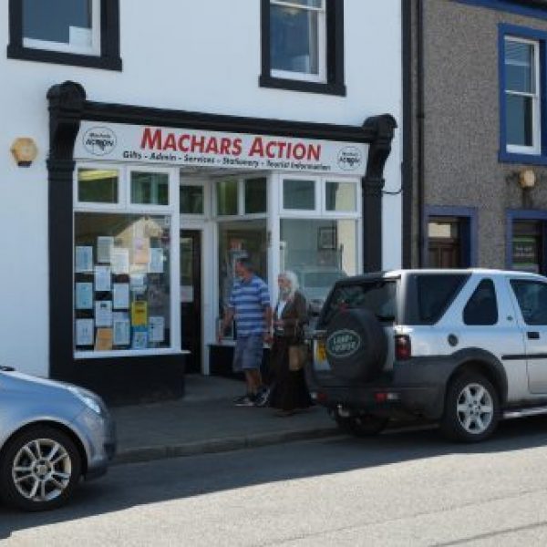 Machars Action Information Centre in Wigtown, Scotland's National Book Town. Cars are parked in front of the building.