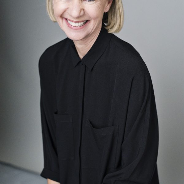 Author Kate Mosse sitting down smiling.