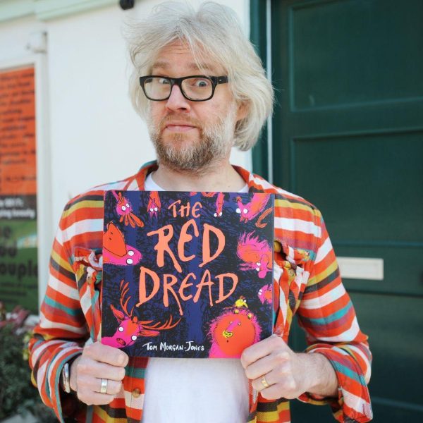 Children's Book Festival author Tom Morgan Jones holds his book 'The Red Dread'.