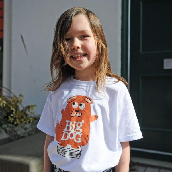 A girl wears a Big Dog book festival t-shirt illustrated with the rusty coloured big dog mascot.