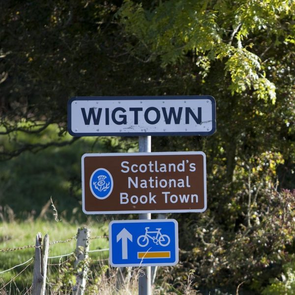 Wigtown: Scotland's National Book Town. Road signage on a grassy verge
